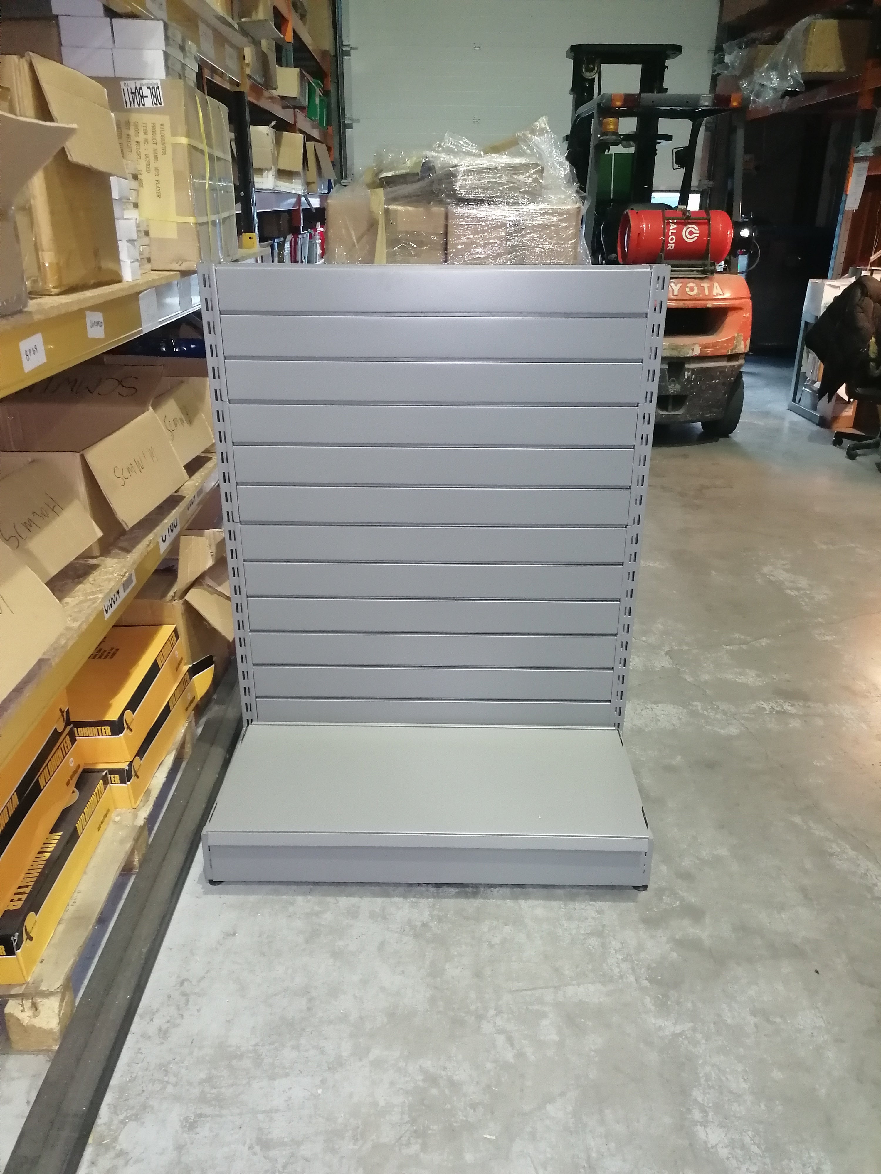 Double Sided grey shop shelving , 1350mm high. With slatwall